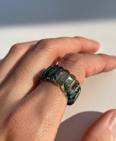 nemo coloured textured glass ring on index finger