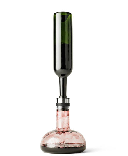 Pour Wine into carafe while aerating